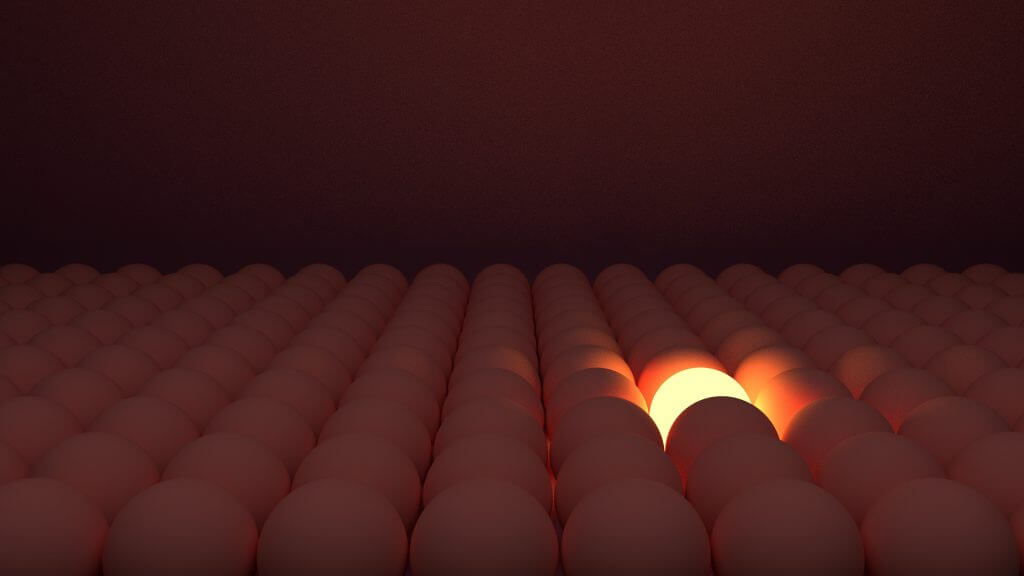 A single egg lit up among dozens of eggs in dark